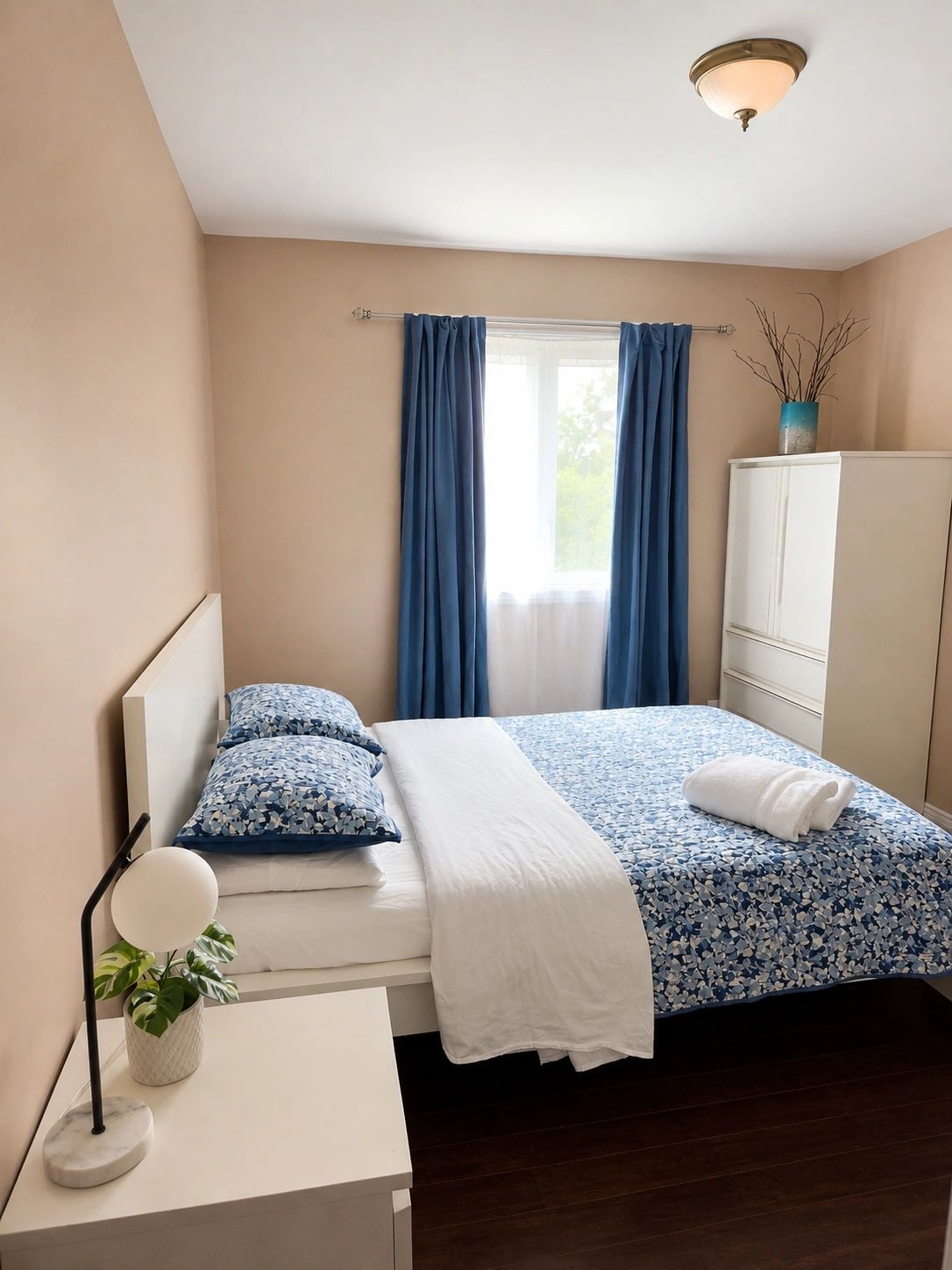 Guest bedroom with blue accents and comfortable double bed